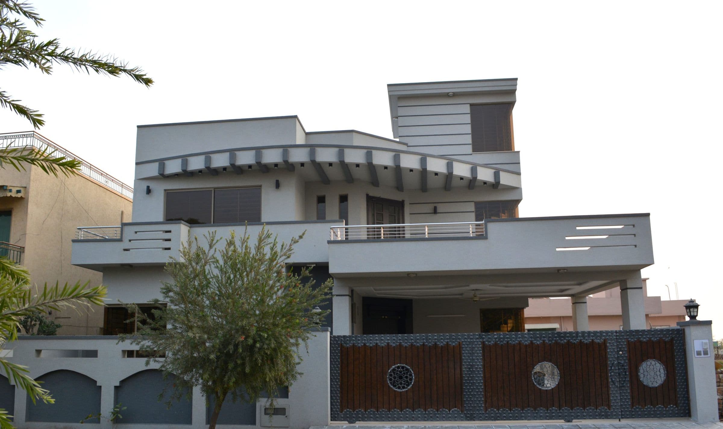 A completed SR Estate & Builders home with a modern gate